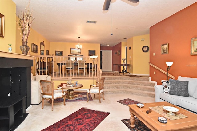 living room with carpet floors and ceiling fan with notable chandelier