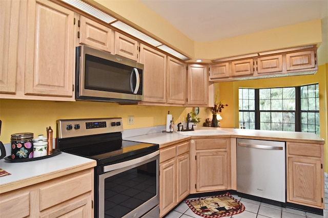 kitchen featuring appliances with stainless steel finishes, sink, light brown cabinetry, and light tile patterned flooring