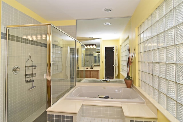 bathroom featuring separate shower and tub and vanity