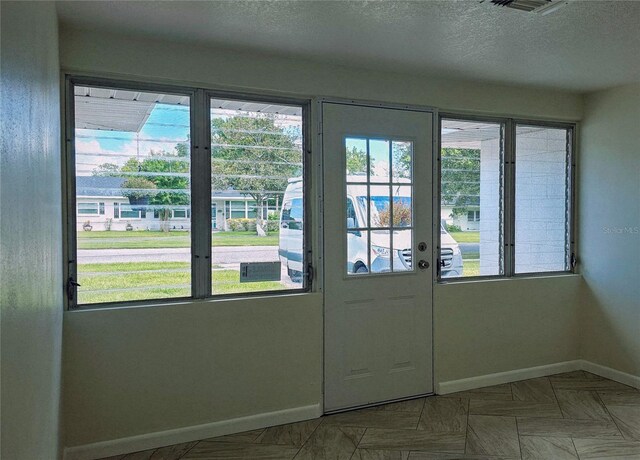 entryway with a textured ceiling