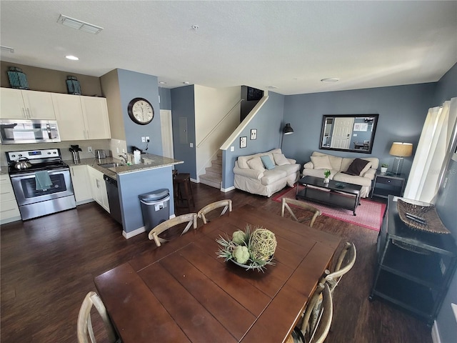 dining area with dark wood-type flooring and sink