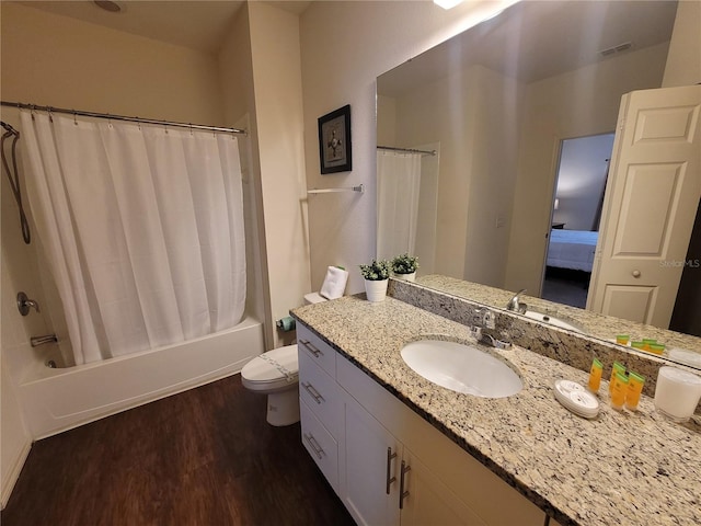 full bathroom featuring vanity, toilet, hardwood / wood-style floors, and shower / bath combo