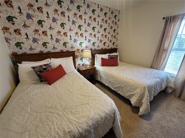 bedroom featuring multiple windows, carpet floors, and wallpapered walls