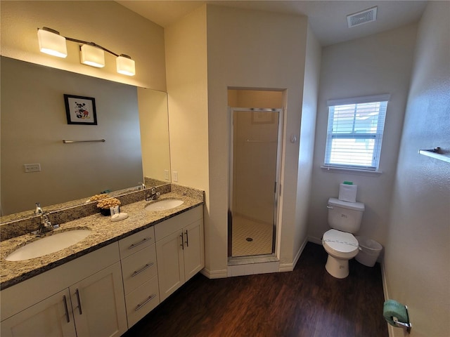 full bathroom featuring visible vents, toilet, wood finished floors, and a sink