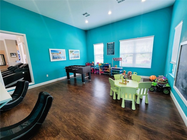 rec room with recessed lighting, wood finished floors, visible vents, and baseboards