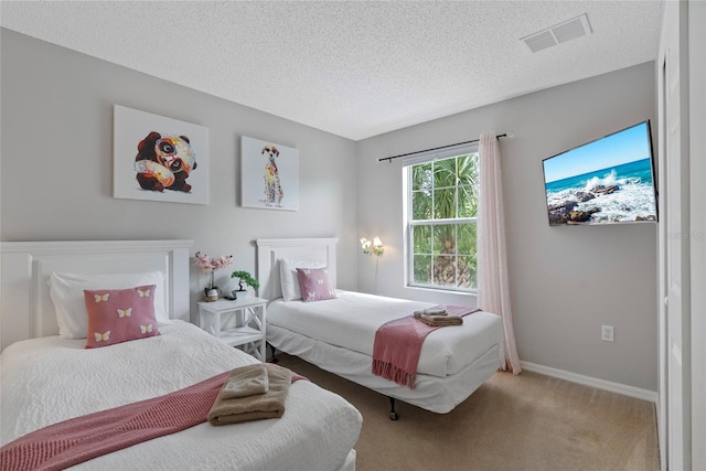 bedroom featuring carpet flooring and a textured ceiling