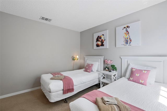 bedroom featuring carpet flooring and a textured ceiling