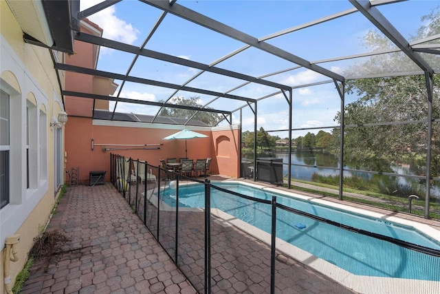 view of swimming pool with a patio, a water view, and a lanai