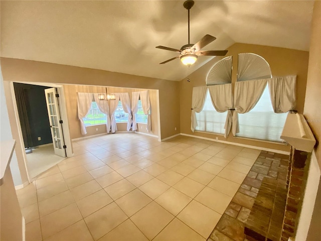 interior space with lofted ceiling, light tile patterned floors, and ceiling fan