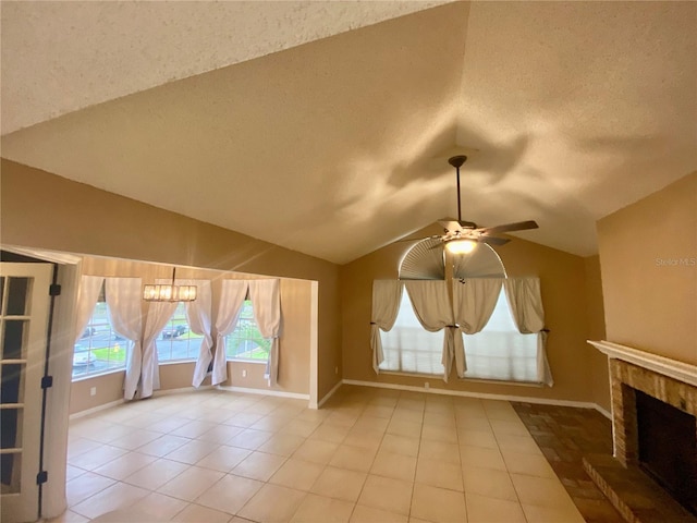 bonus room with lofted ceiling, ceiling fan, light tile patterned floors, and a textured ceiling