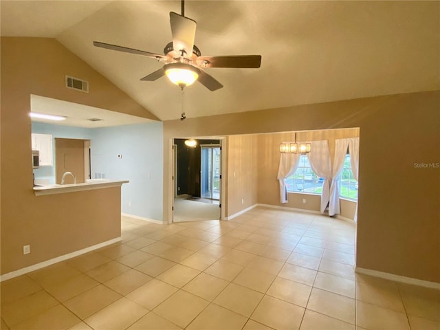 tiled spare room with lofted ceiling and ceiling fan