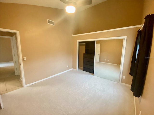 unfurnished bedroom featuring ceiling fan, a closet, and carpet floors