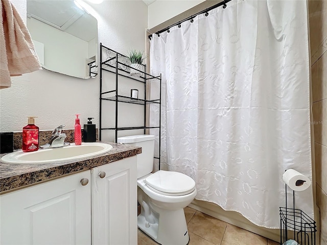 bathroom featuring tile patterned flooring, vanity, and toilet