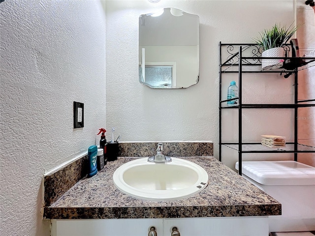 bathroom featuring vanity and toilet