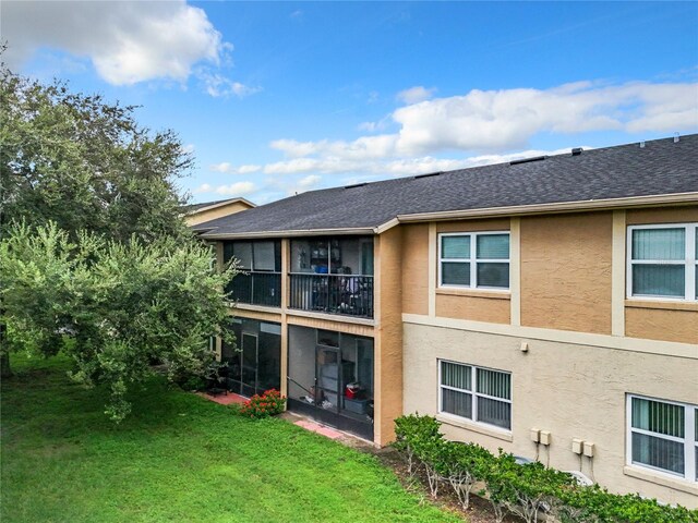 rear view of property with a lawn