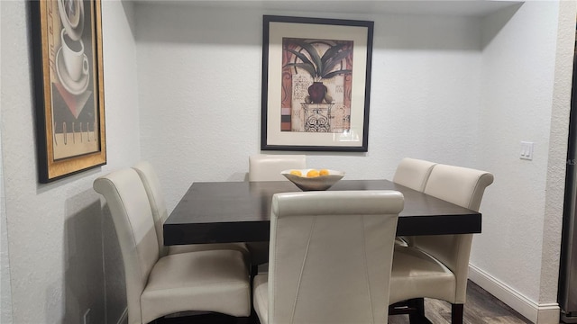 dining space featuring dark hardwood / wood-style floors