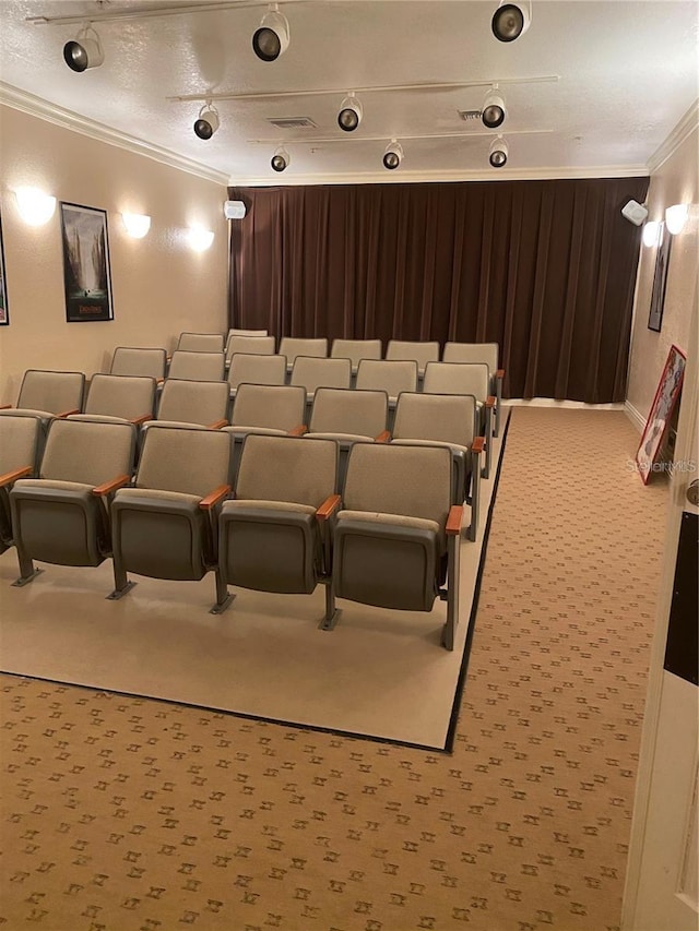 cinema featuring a textured ceiling, crown molding, and carpet floors