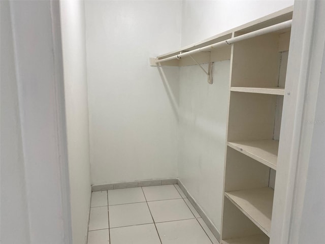 spacious closet with light tile patterned floors