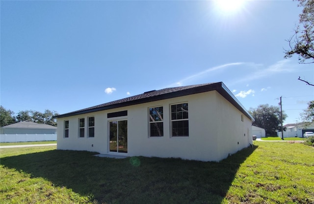 rear view of property with a lawn