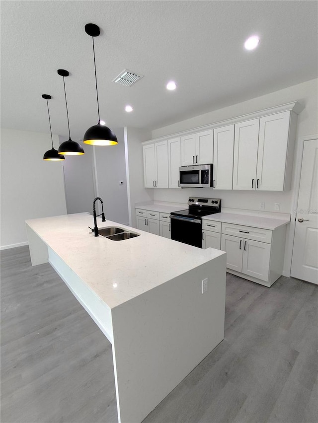 kitchen featuring white cabinetry, stainless steel appliances, sink, and light hardwood / wood-style floors