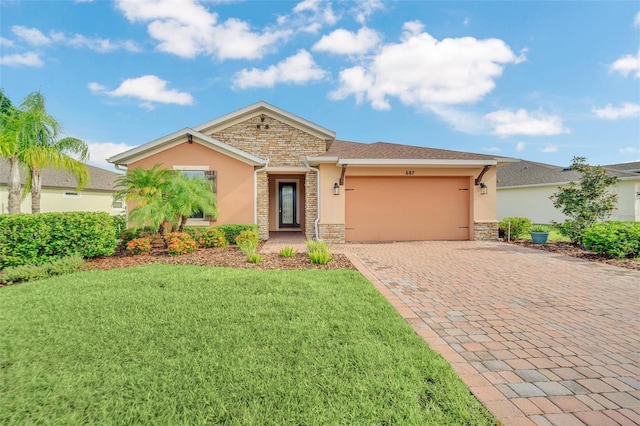 single story home featuring a garage and a front lawn