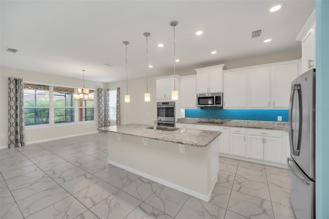 kitchen featuring appliances with stainless steel finishes, backsplash, white cabinetry, and sink