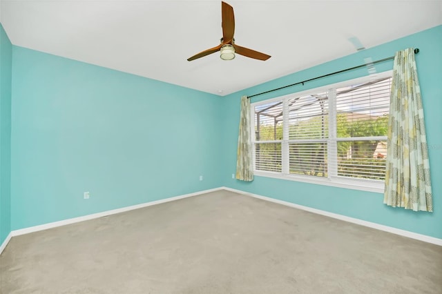 carpeted spare room with ceiling fan