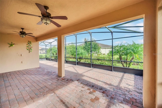 view of patio / terrace with ceiling fan and glass enclosure