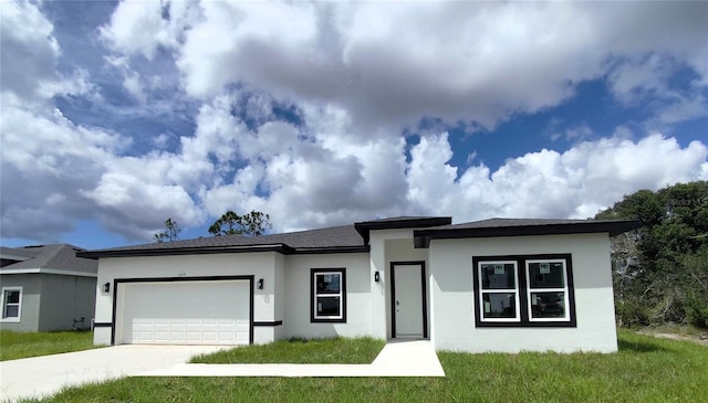 view of front facade with a garage and a front yard