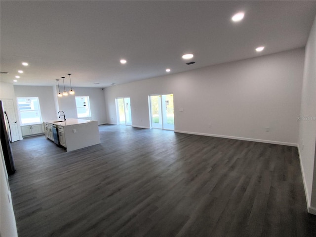 interior space featuring dark hardwood / wood-style floors, plenty of natural light, and sink