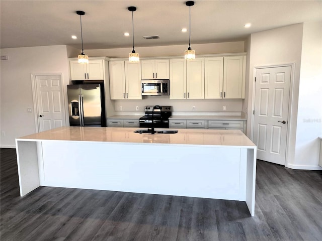 kitchen featuring white cabinets, a large island, and appliances with stainless steel finishes