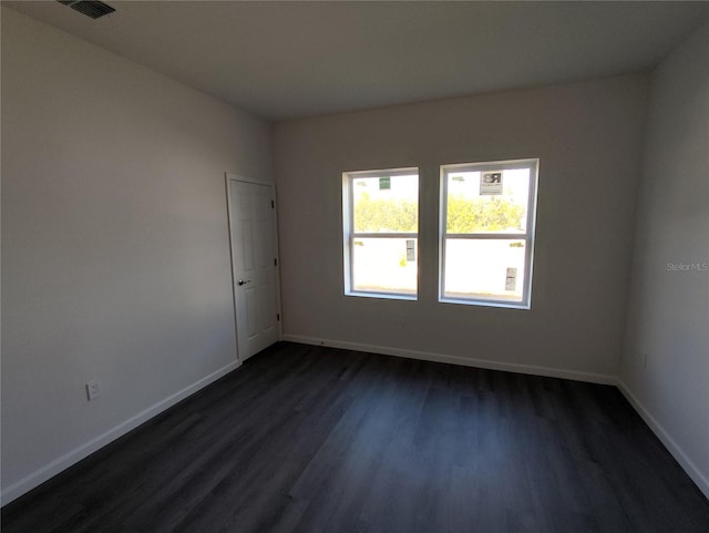 unfurnished room featuring dark hardwood / wood-style flooring