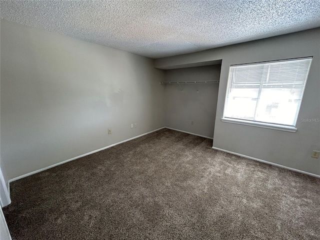 unfurnished bedroom featuring a closet, carpet, and a textured ceiling