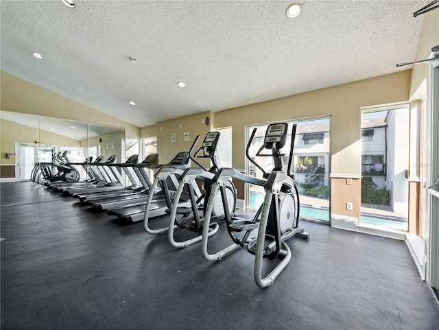 gym with a textured ceiling and vaulted ceiling