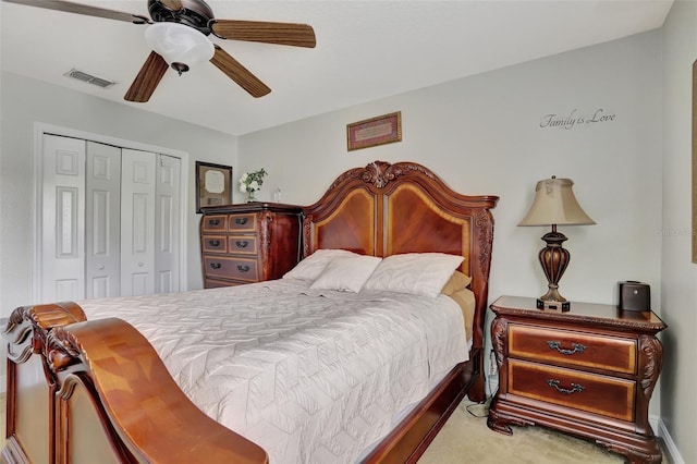 carpeted bedroom featuring ceiling fan and a closet