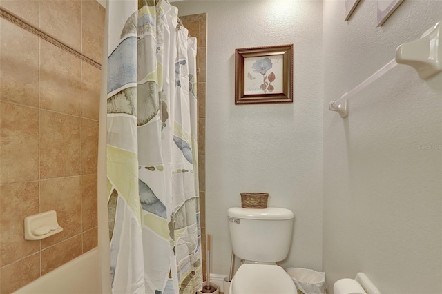 bathroom featuring toilet and shower / bathtub combination with curtain