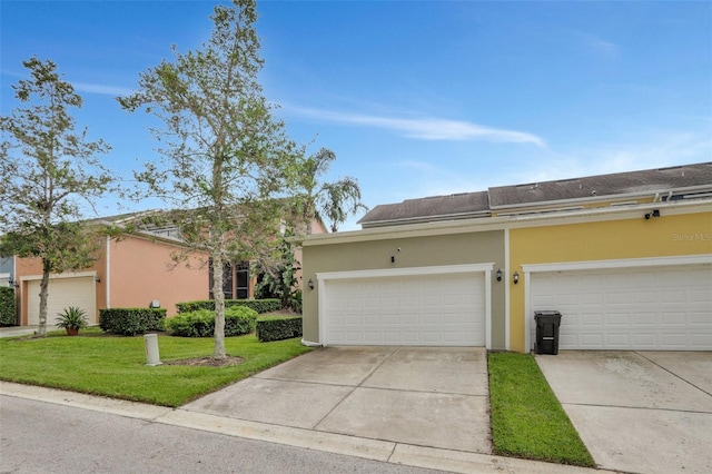 single story home with a garage and a front lawn