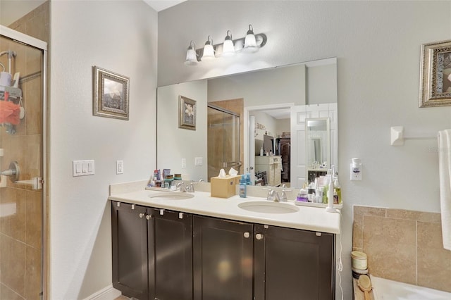 bathroom featuring vanity and an enclosed shower