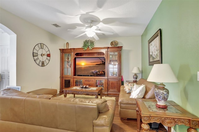 living room with light wood-type flooring and ceiling fan