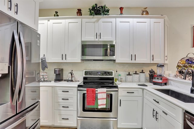 kitchen featuring white cabinetry, stainless steel appliances, and sink