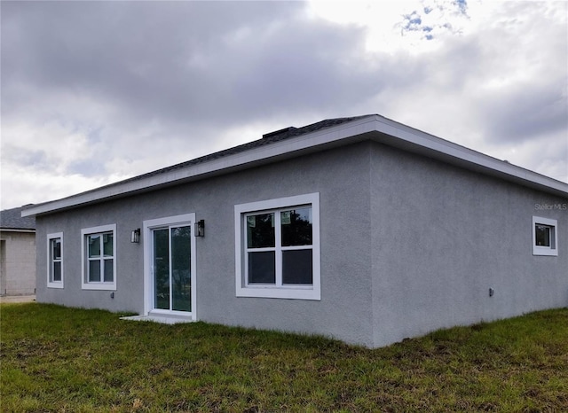 view of home's exterior with a lawn