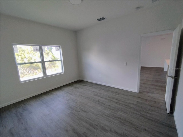 unfurnished room featuring dark wood-type flooring