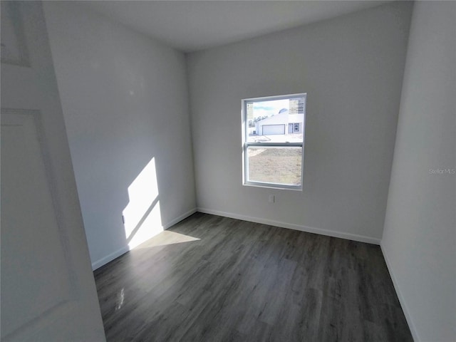 unfurnished room with dark hardwood / wood-style floors