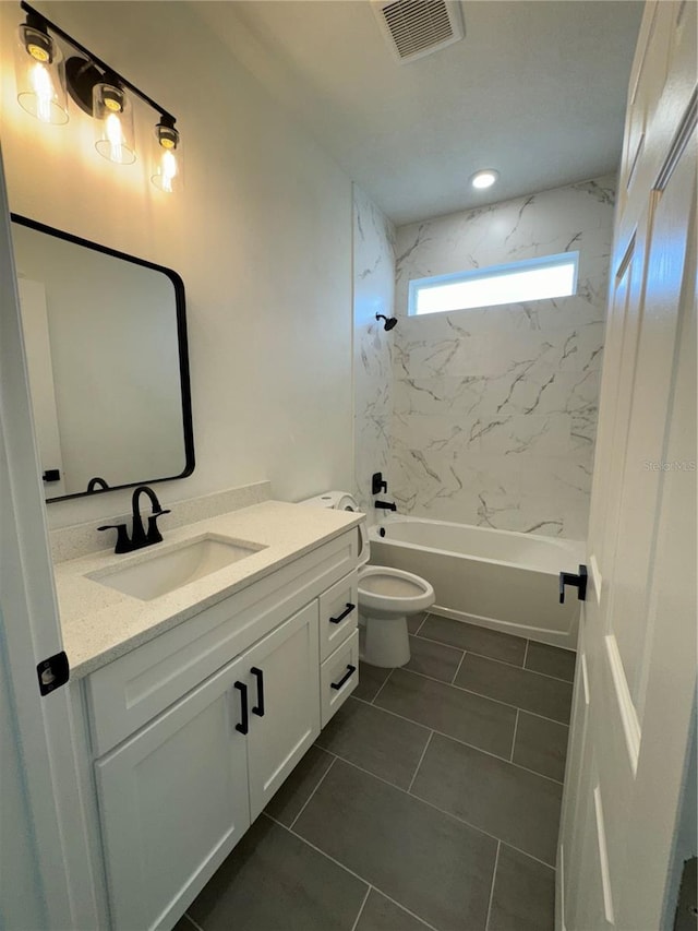 full bathroom with tiled shower / bath, tile patterned flooring, vanity, and toilet