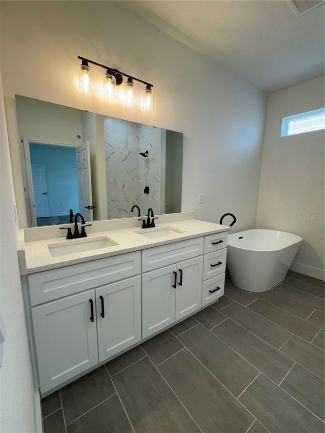 bathroom with vanity and shower with separate bathtub