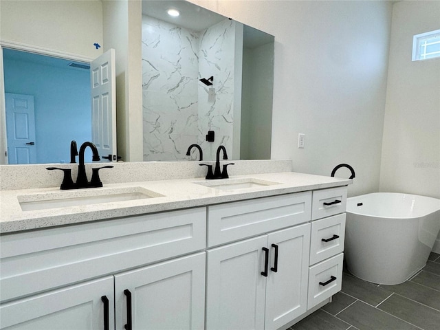 bathroom with a washtub and vanity