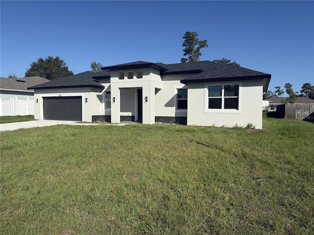 view of front of property with a front yard and a garage