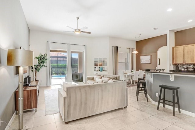 tiled living room with ceiling fan