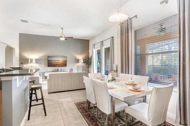 dining space with ceiling fan and light tile patterned floors