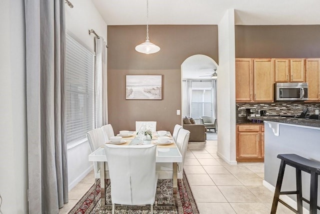 dining space with ceiling fan and light tile patterned floors